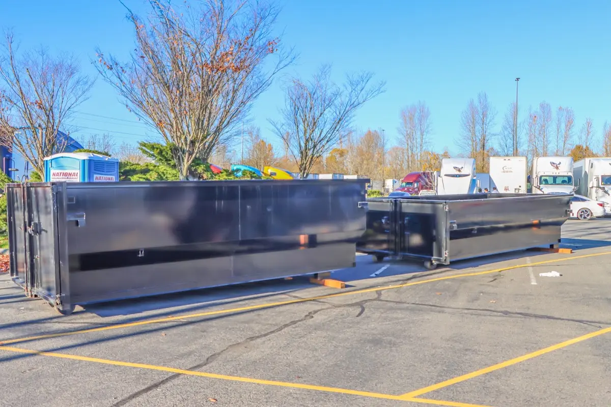 Professional dumpster rental service with roll-off container on residential driveway in Highland Village